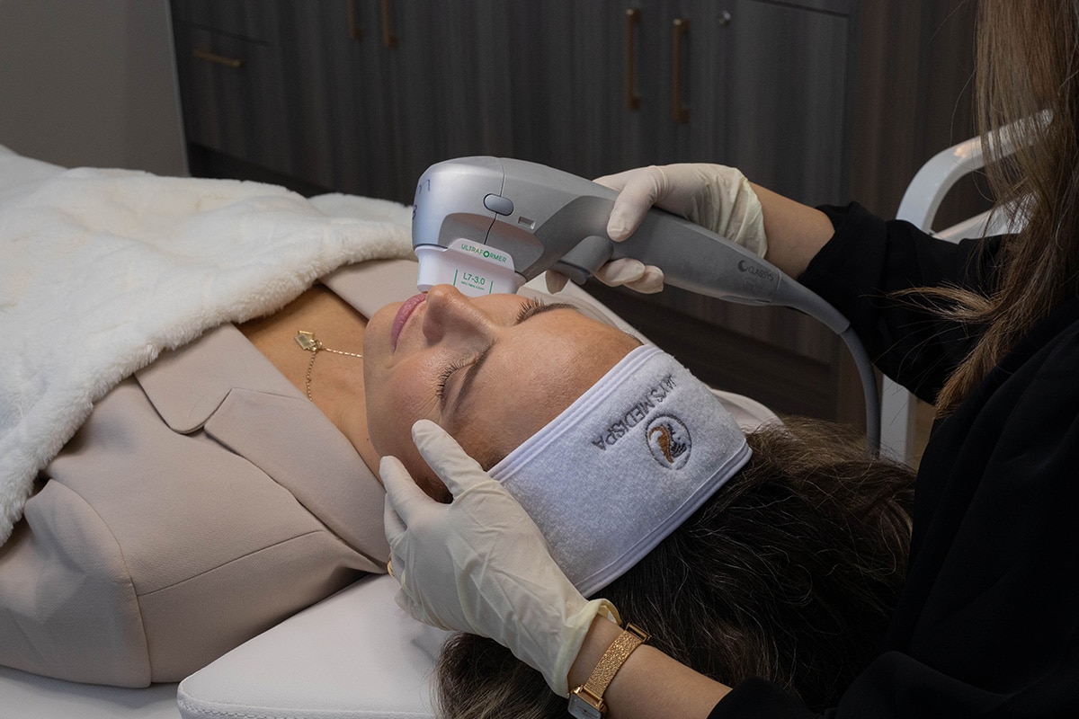 Client receiving a non-invasive facial treatment at Jay’s Medispa with an Ultrafomer device.