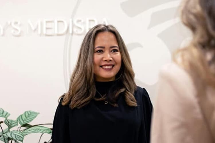 Registered nurse injector smiling during a client consultation at Jay’s Medispa in Birkenhead.