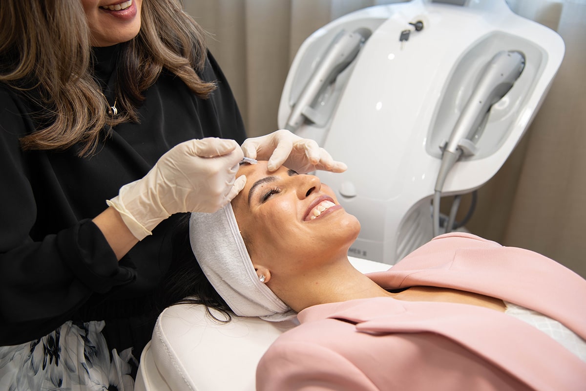 Client receiving a gentle injectable treatment at Jay’s Medispa, smiling during the procedure.